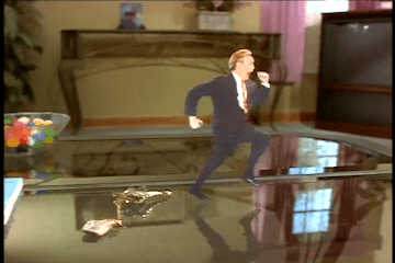 Still from a video featuring Gordon Elliott digitally edited to appear to be running across a coffee table.