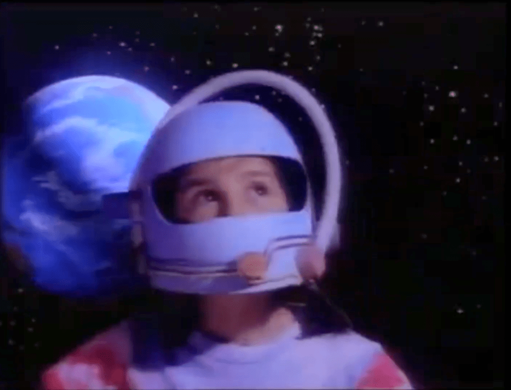 A digital composite image featuring a photograph of a girl in a homemade astronaut helmet over a drawing of the earth as seen from space.